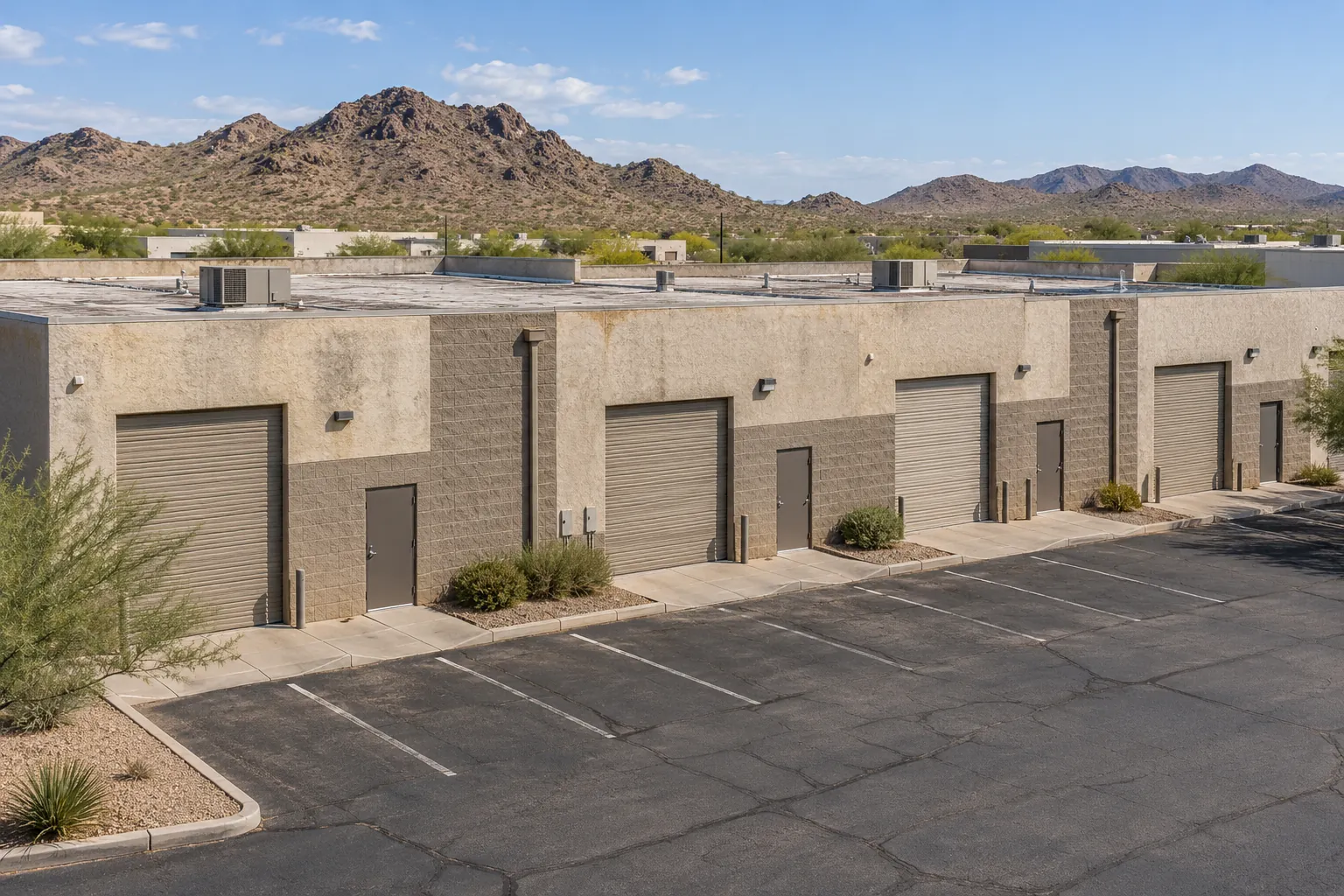 Block flex-industrial building with roll-up doors and a flat roof