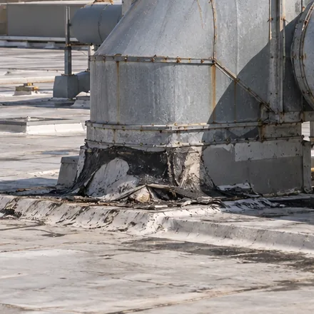 Close view of a duct support and its flashing on an industrial roof